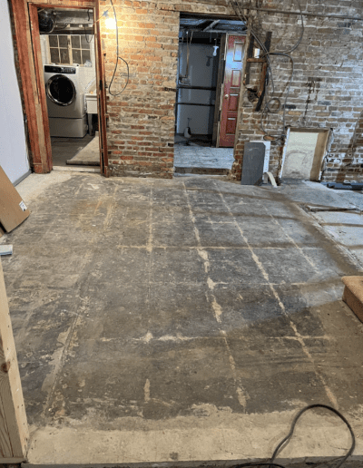 image shows a wooden floor that appears to be undergoing a sanding process