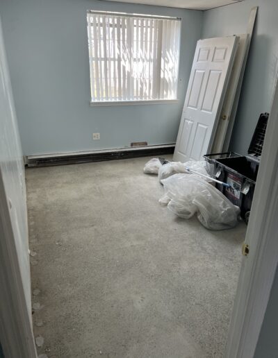 image shows an empty room with light blue walls and a carpeted floor