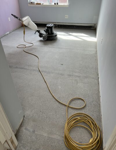 Clean floor with a machine positioned for flooring work, indicating an ongoing or completed project