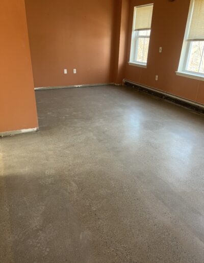 Clean floor with a smooth finish, accompanied by a wall painted in vibrant orange