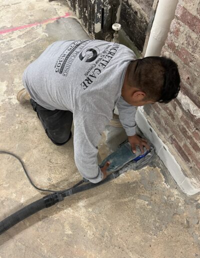 A man repairing a floor leakage using a machine