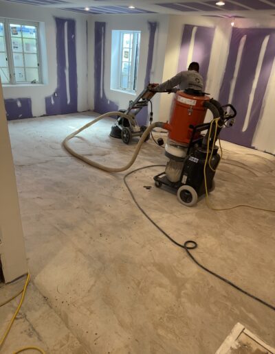 A man using a vacuum to clean a room