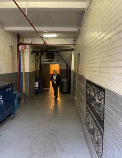 A man is walking down a long hallway