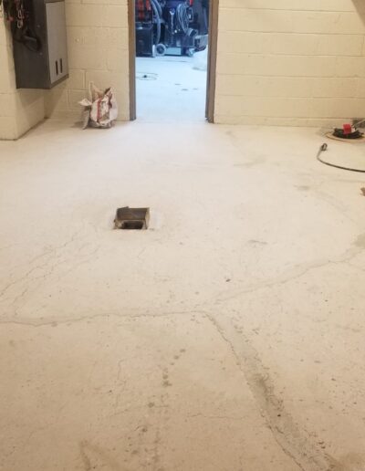 A garage with a white floor and a clock on the wall